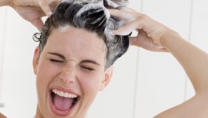 Happy woman washing her hair